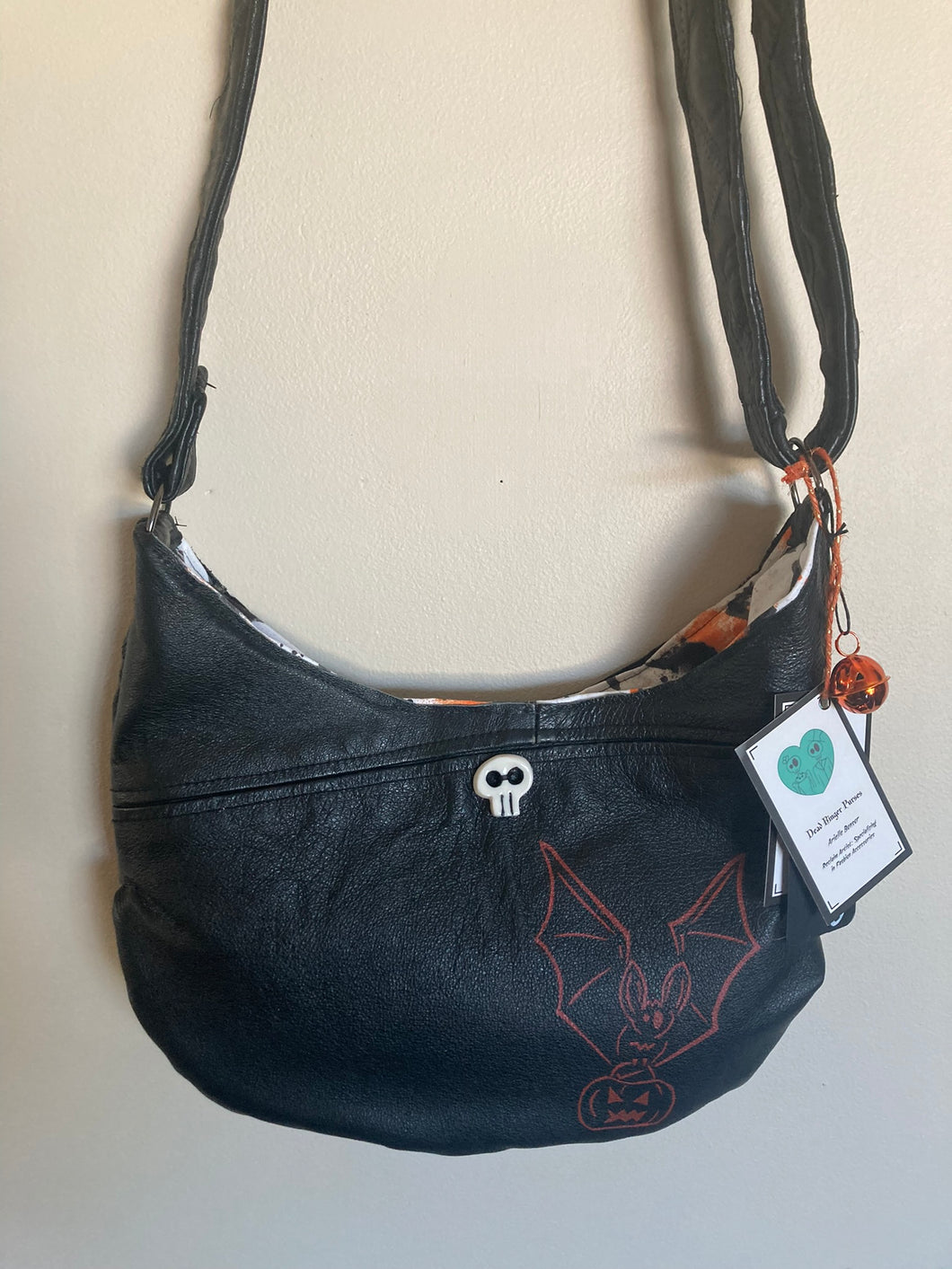 Black Crescent Moon bag with a orange print of 